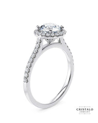 Aphrodite halo engagement ring with an oval-cut diamond in 18k white gold.