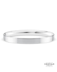 A modern wedding band in 18k white gold. Features a sharp, clean edge and a rounded interior for comfort.