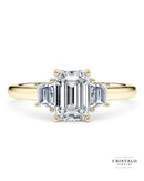 The Imperia Trilogy engagement ring with three step-cut emerald diamonds in 18k yellow gold. The ring has a total carat weight of 0.43ct and a vintage design.